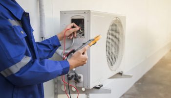 technician checking the operation of the air conditioner