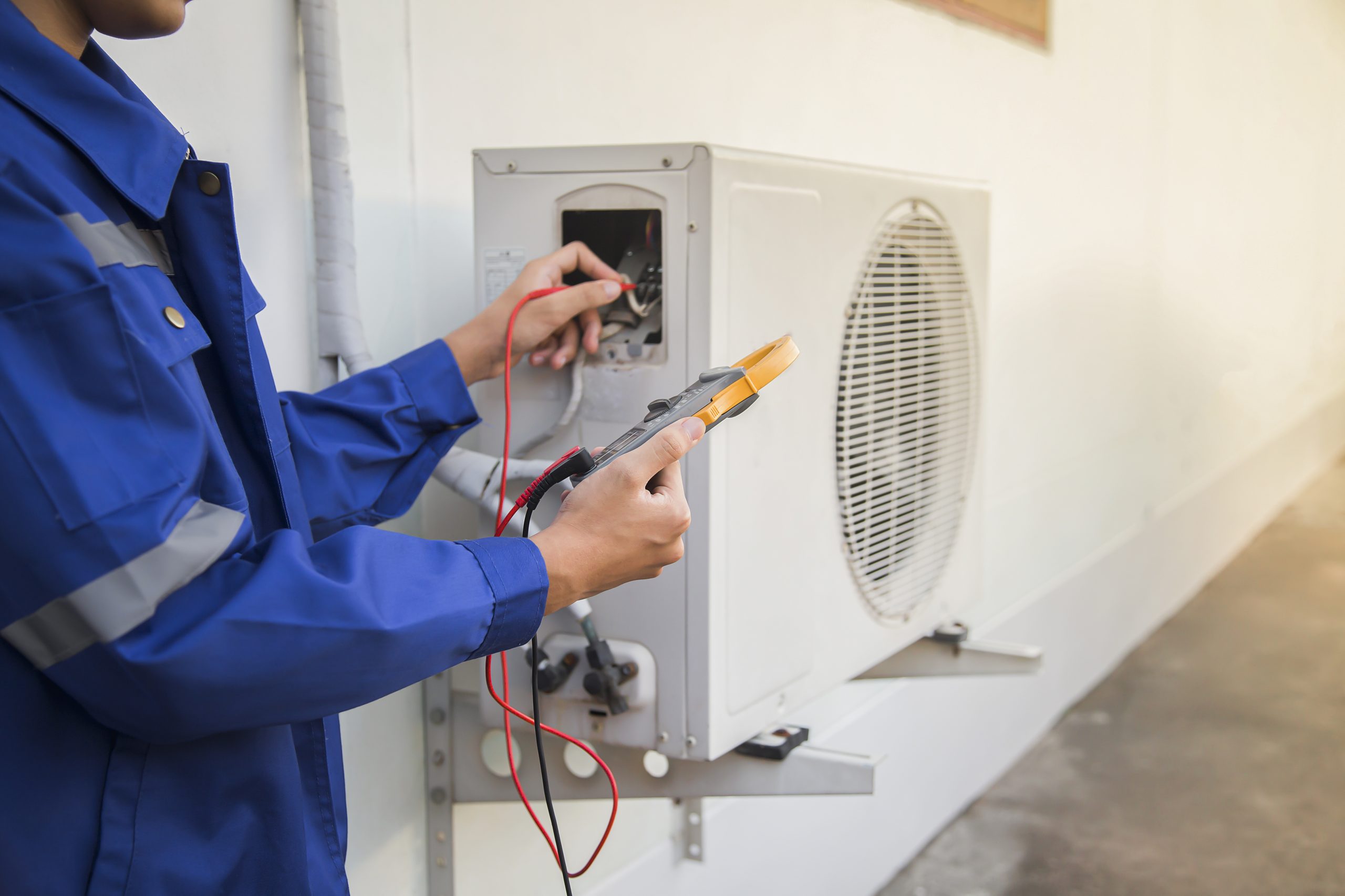 technician checking the operation of the air conditioner